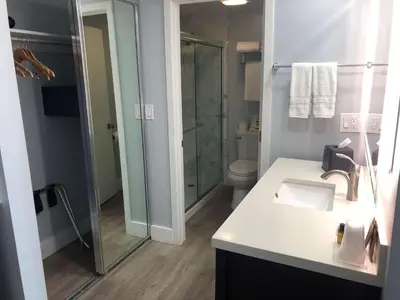 a bathroom with a shower and a sink and a toilet at Best Western Plus Dana Point Inn-by-the-Sea in Dana Point