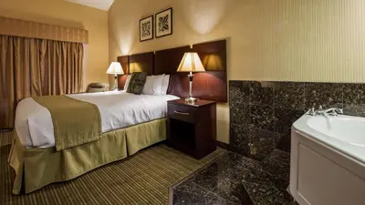 a hotel room with a bed and a sink at Best Western Plus Dana Point Inn-by-the-Sea in Dana Point