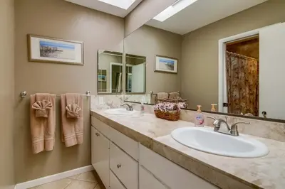 a bathroom with two sinks and a large mirror at PACIFIC BEACH MANSION in San Diego