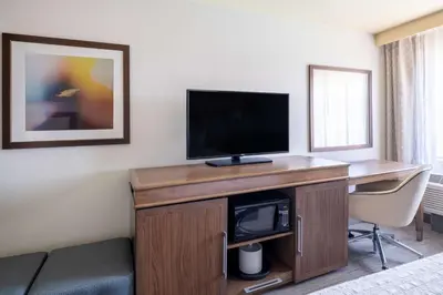 a hotel room with a desk with a tv and a room at Hampton Inn by Hilton Irvine East - Lake Forest in Foothill Ranch