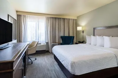 a hotel room with a bed and a flat screen tv at Hampton Inn by Hilton Irvine East - Lake Forest in Foothill Ranch