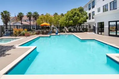 a large pool with blue water in a building at Hampton Inn by Hilton Irvine East - Lake Forest in Foothill Ranch