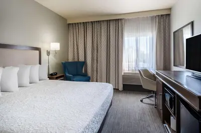 a hotel room with a bed and a desk and a television at Hampton Inn by Hilton Irvine East - Lake Forest in Foothill Ranch