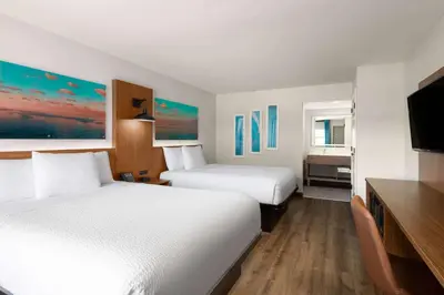 a hotel room with two beds and a flat screen tv at La Quinta Inn by Wyndham San Diego - Miramar in Sabre Springs