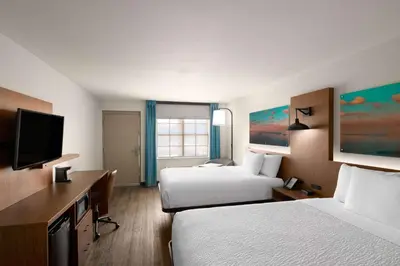 a hotel room with two beds and a flat screen tv at La Quinta Inn by Wyndham San Diego - Miramar in Sabre Springs