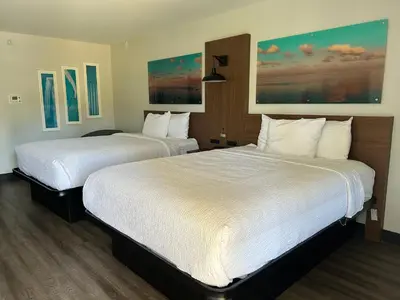two beds in a hotel room with white sheets at La Quinta Inn by Wyndham San Diego - Miramar in Sabre Springs