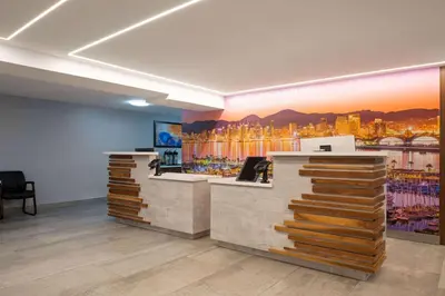 an office with a reception desk with a painting on the wall at La Quinta Inn by Wyndham San Diego - Miramar in Sabre Springs