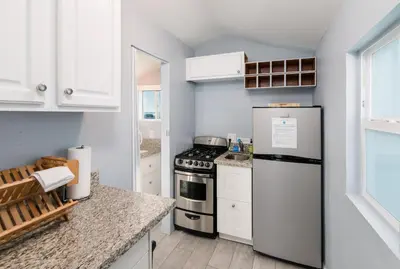 a kitchen with a refrigerator and a stove at Pacific Bungalow in Oceanside with Backyard & Tiny House in Oceanside
