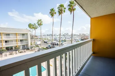 a balcony with palm trees and a view of a harbor at Dana Point Marina Inn in Dana Point