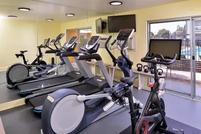 a row of cardio machines in a gym at Dana Point Marina Inn in Dana Point
