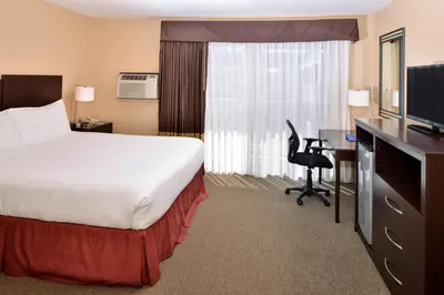 a hotel room with a bed and a desk with a computer at Dana Point Marina Inn in Dana Point