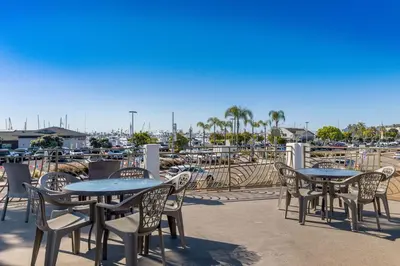 a patio with tables and chairs and a marina at Comfort Inn San Diego Airport At The Harbor in San Diego