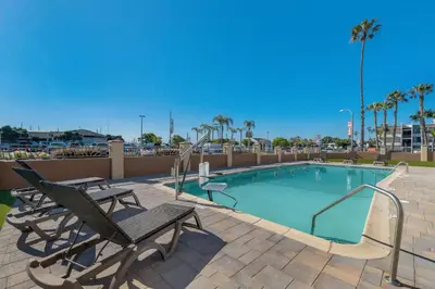 a swimming pool with two chairs and a bench at Comfort Inn San Diego Airport At The Harbor in San Diego