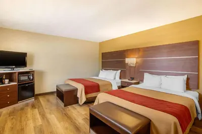 a hotel room with two beds and a flat screen tv at Comfort Inn San Diego Airport At The Harbor in San Diego