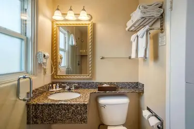 a bathroom with a sink and a toilet and a mirror at Comfort Inn San Diego Airport At The Harbor in San Diego