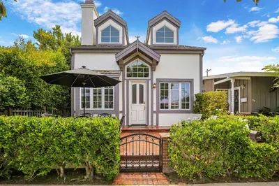 a white house with an umbrella in front of it at 416 Dahlia in Newport Beach