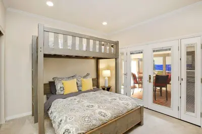 a bedroom with a bunk bed and a balcony at 416 Dahlia in Newport Beach