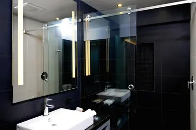 a bathroom with a sink and a mirror at Hercor Hotel - Urban Boutique in Chula Vista