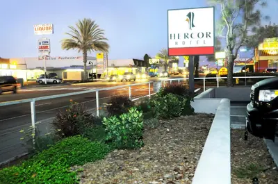 a sign for a hotel on the side of a street at Hercor Hotel - Urban Boutique in Chula Vista