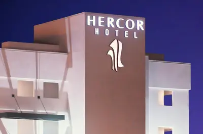 a hotel sign on the side of a building at Hercor Hotel - Urban Boutique in Chula Vista