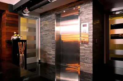 a elevator in a room with a brick wall at Hercor Hotel - Urban Boutique in Chula Vista