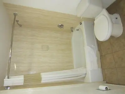 a bathroom with a toilet and a shower stall at Northgate Motel in El Cajon