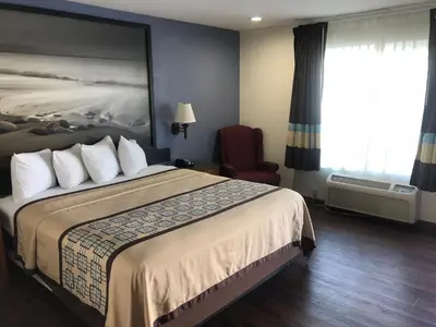 a hotel room with a bed and a chair at Northgate Motel in El Cajon