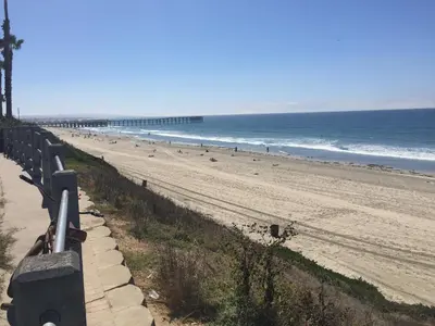 a view of a beach with a fence and the ocean at Diamond Head Inn in San Diego