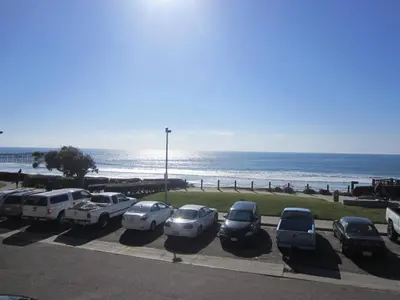 a parking lot with cars parked next to the beach at Diamond Head Inn in San Diego