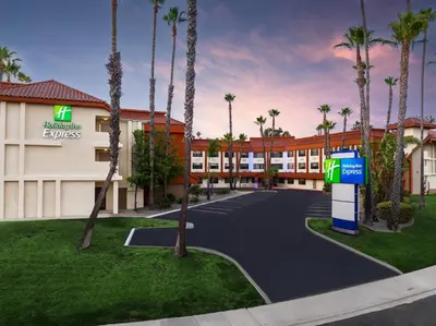 a rendering of the front of a hotel with palm trees at Holiday Inn Express La Mesa Near SDSU by IHG in La Mesa