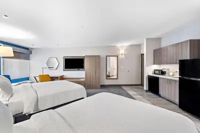 a hotel room with two beds and a kitchen at Holiday Inn Express La Mesa Near SDSU by IHG in La Mesa