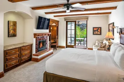 a bedroom with a white bed and a fireplace at Omni La Costa Resort & Spa Carlsbad in Carlsbad