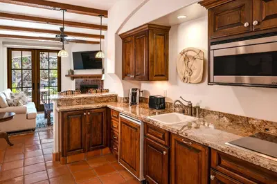 a kitchen with wooden cabinets and a sink at Omni La Costa Resort & Spa Carlsbad in Carlsbad