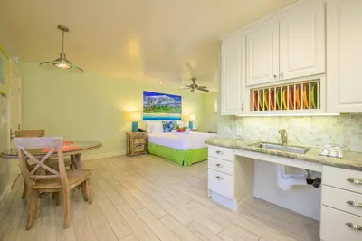 a kitchen with a sink and a bed in a room at Ocean Palms Beach Resort in Carlsbad