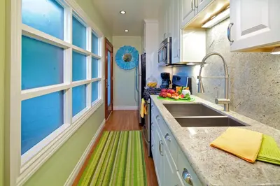 a kitchen with a sink and a window at Ocean Palms Beach Resort in Carlsbad