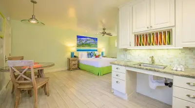 a kitchen with a sink and a bed in a room at Ocean Palms Beach Resort in Carlsbad