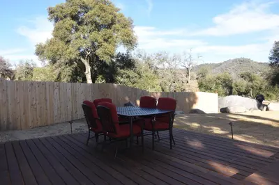 a patio table and chairs on a deck at Apple Tree Inn in Julian