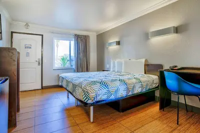 a hotel room with a bed and a window at Motel 6-Menifee, CA in Menifee