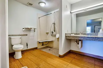 a bathroom with a toilet and a shower and a sink at Motel 6-Menifee, CA in Menifee