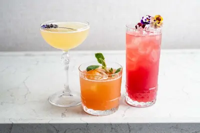 three cocktails sitting on a counter next to each other at Hotel La Jolla, Curio Collection by Hilton in San Diego