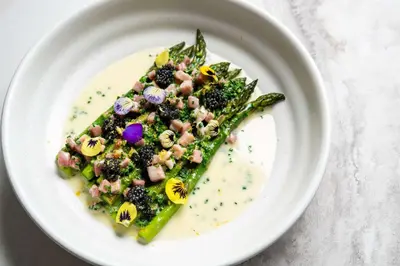 a white plate of food with a salad on it at Hotel La Jolla, Curio Collection by Hilton in San Diego