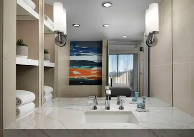 a bathroom with a sink and a mirror at Hotel La Jolla, Curio Collection by Hilton in San Diego