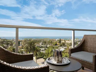 a balcony with chairs and a table with a view of the ocean at Hotel La Jolla, Curio Collection by Hilton in San Diego