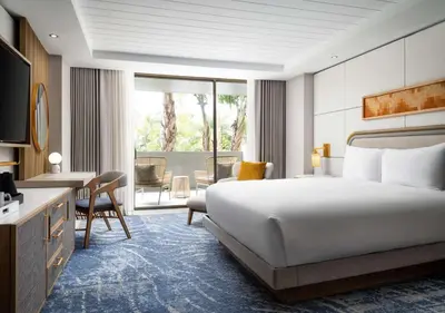 a hotel room with a large bed and a desk at Hotel La Jolla, Curio Collection by Hilton in San Diego