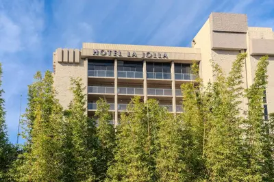 a hotel building with trees in front of it at Hotel La Jolla, Curio Collection by Hilton in San Diego
