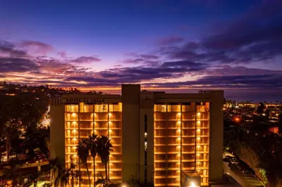 a building with lights in front of a city at Hotel La Jolla, Curio Collection by Hilton in San Diego