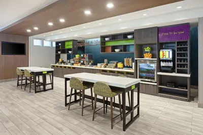 a restaurant with two tables and chairs and a counter at Home2 Suites By Hilton Temecula in Temecula