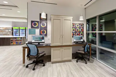 an office with a desk with two computers and two chairs at Home2 Suites By Hilton Temecula in Temecula