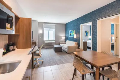 a kitchen and living room with a table and a living room at Home2 Suites By Hilton Temecula in Temecula