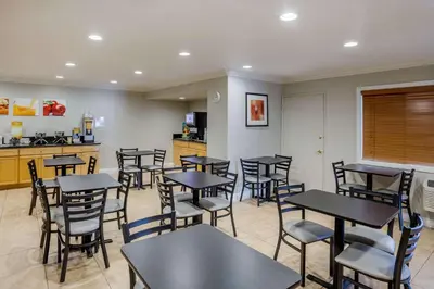 a restaurant with tables and chairs and a kitchen at Quality Inn & Suites El Cajon San Diego East in El Cajon